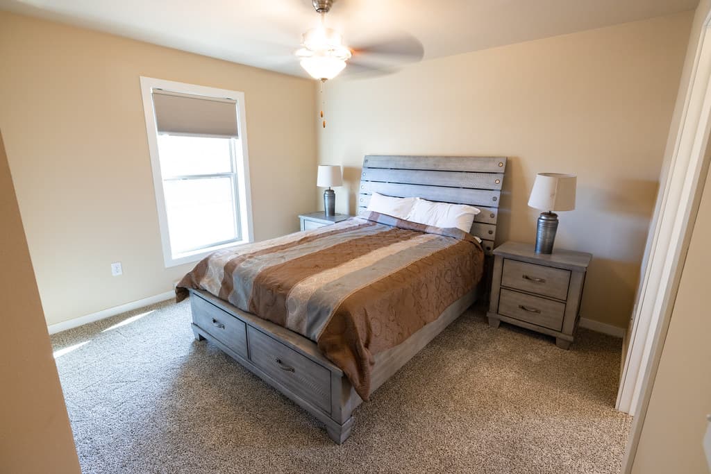 A bed in a darkened bedroom