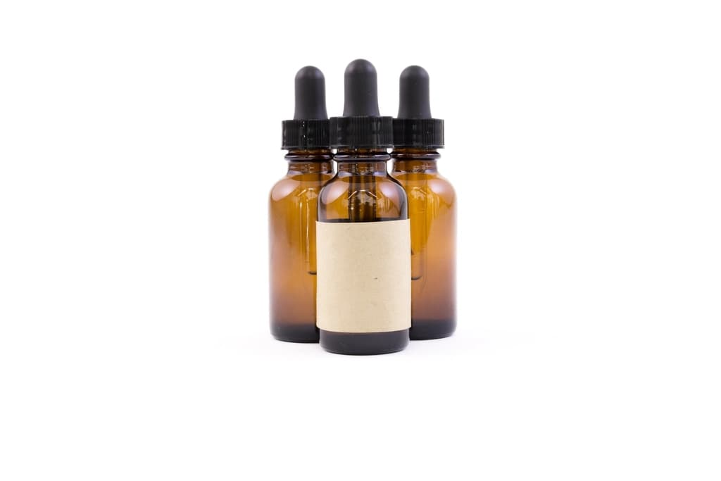 A vitamin C serum beside citrus fruit