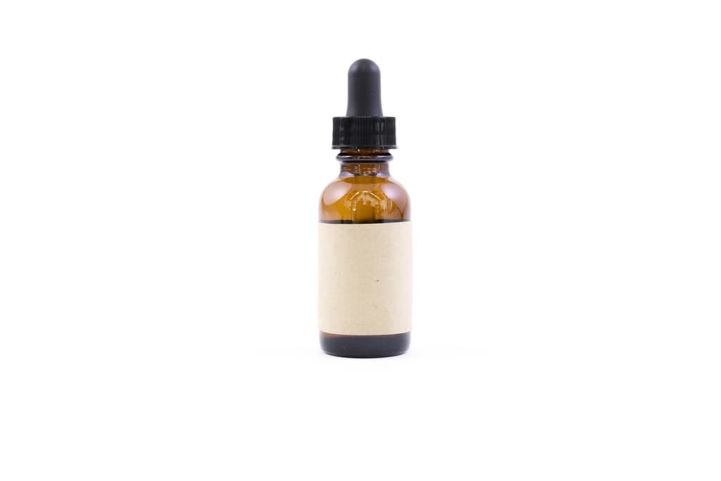 A skincare serum bottle with a dropper