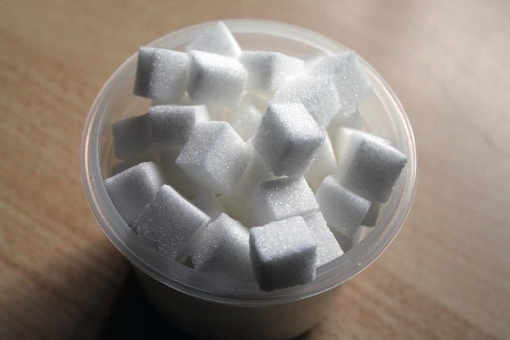Sweetener sachets beside sugar