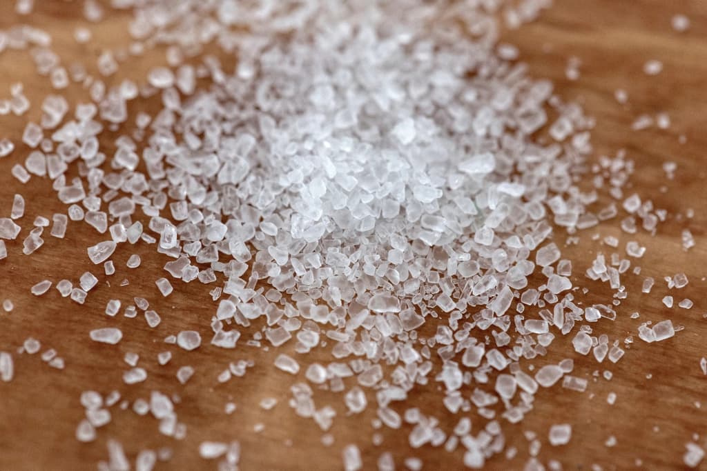 A small bowl of salt with a spoon