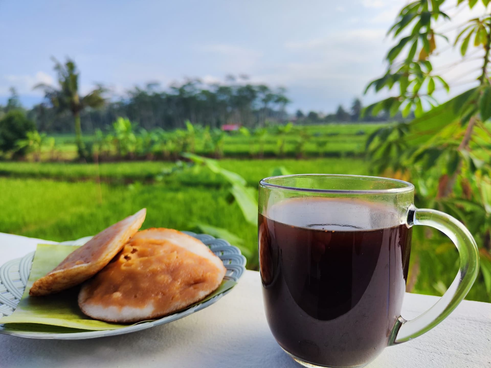 A cup of green tea with loose leaves